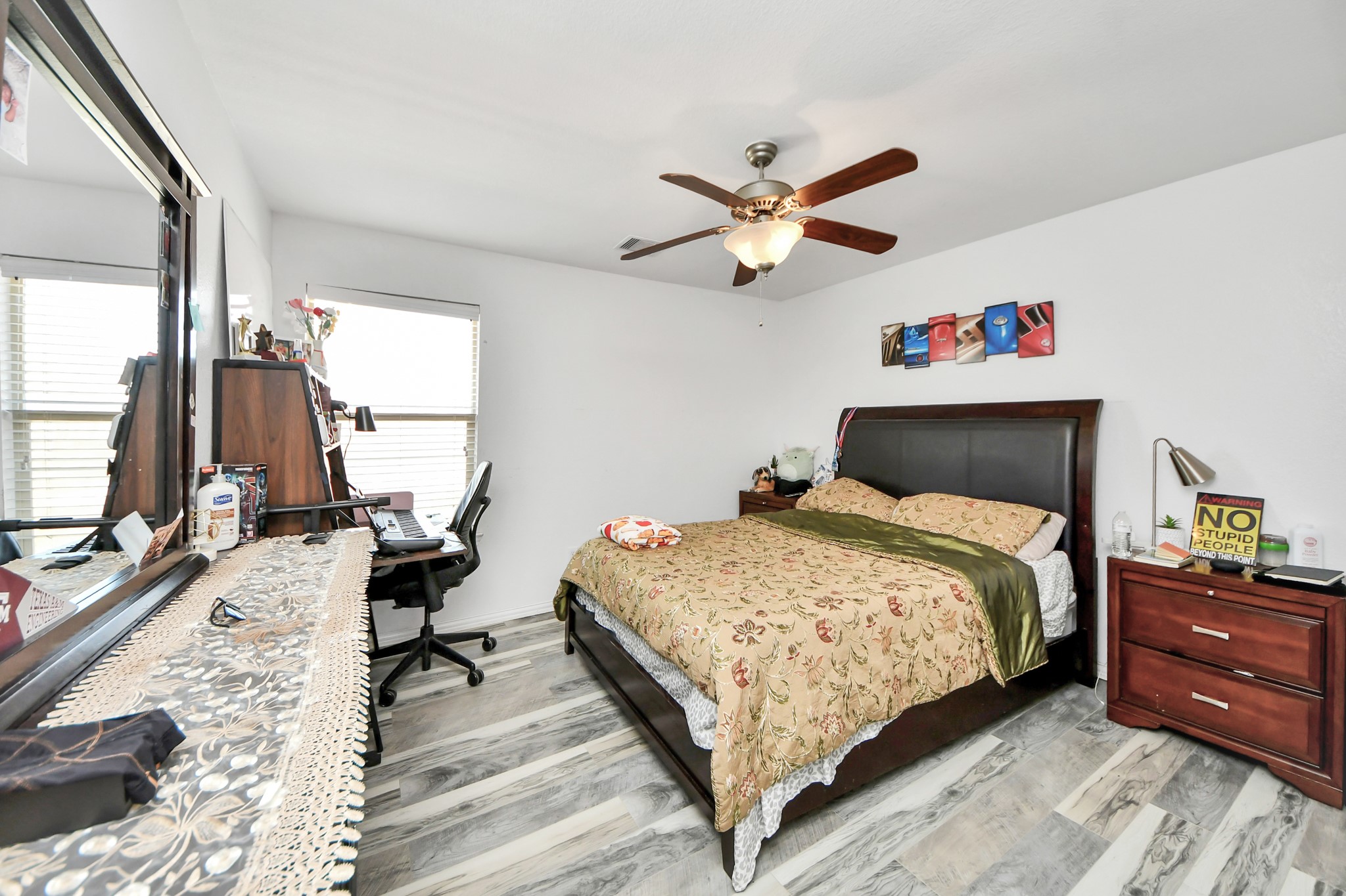 12119 Redbud Brook Trail Houston, TX 77089 - Photo 44 of 48 a bedroom with a bed and a chandelier