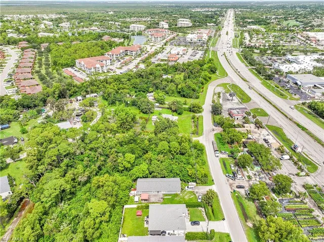 an aerial view of residential houses with outdoor space and swimming pool