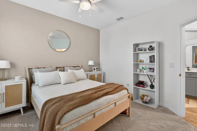 a bedroom with bed and a chandelier