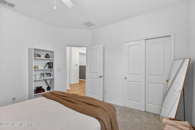 a bedroom with a bed and a closet