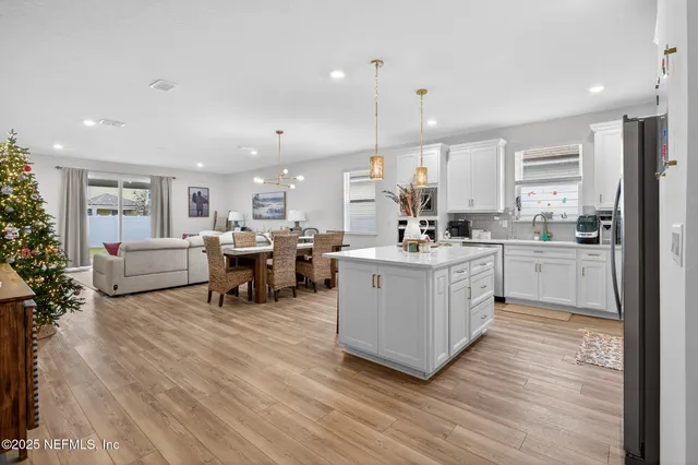 a large white kitchen with lots of counter space and a sink