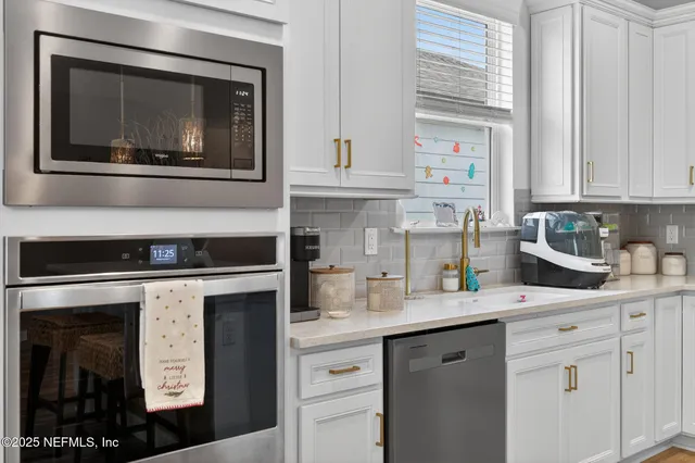 a kitchen with stainless steel appliances granite countertop a stove and cabinets