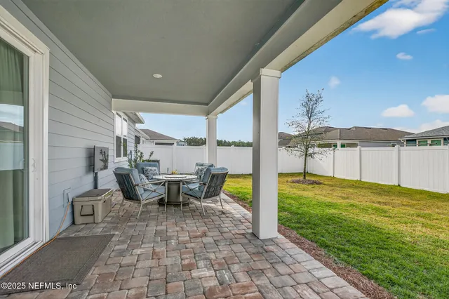 a view of a patio with a dining table and chairs