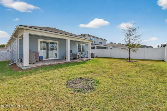 a view of a house with a backyard