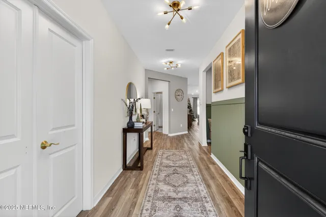 a view of a hallway to a livingroom with furniture