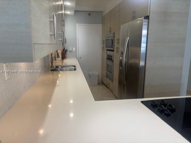 100 Lincoln Road, Unit 823 Miami Beach, FL 33139 - Photo 5 of 15 a kitchen with stainless steel appliances a refrigerator and a sink