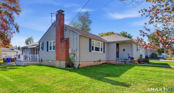 a front view of house with yard and outdoor seating