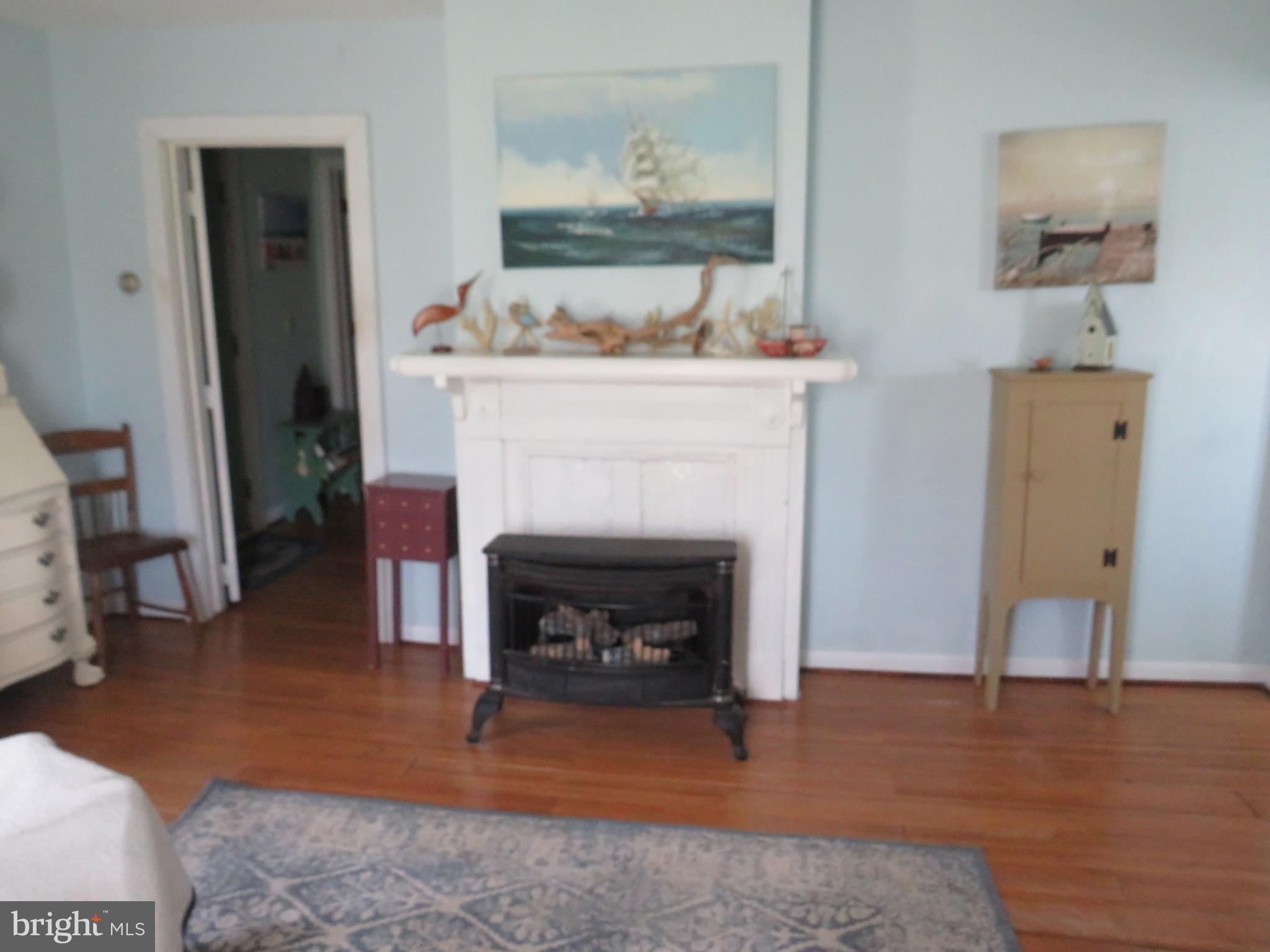 3289 Sackertown Road Crisfield, MD 21817 - Photo 11 of 25 a living room with furniture and a fireplace