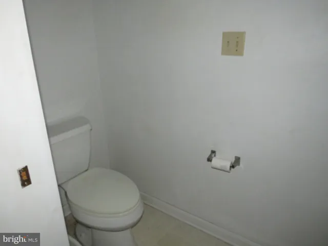 a white toilet sitting next to a white sink