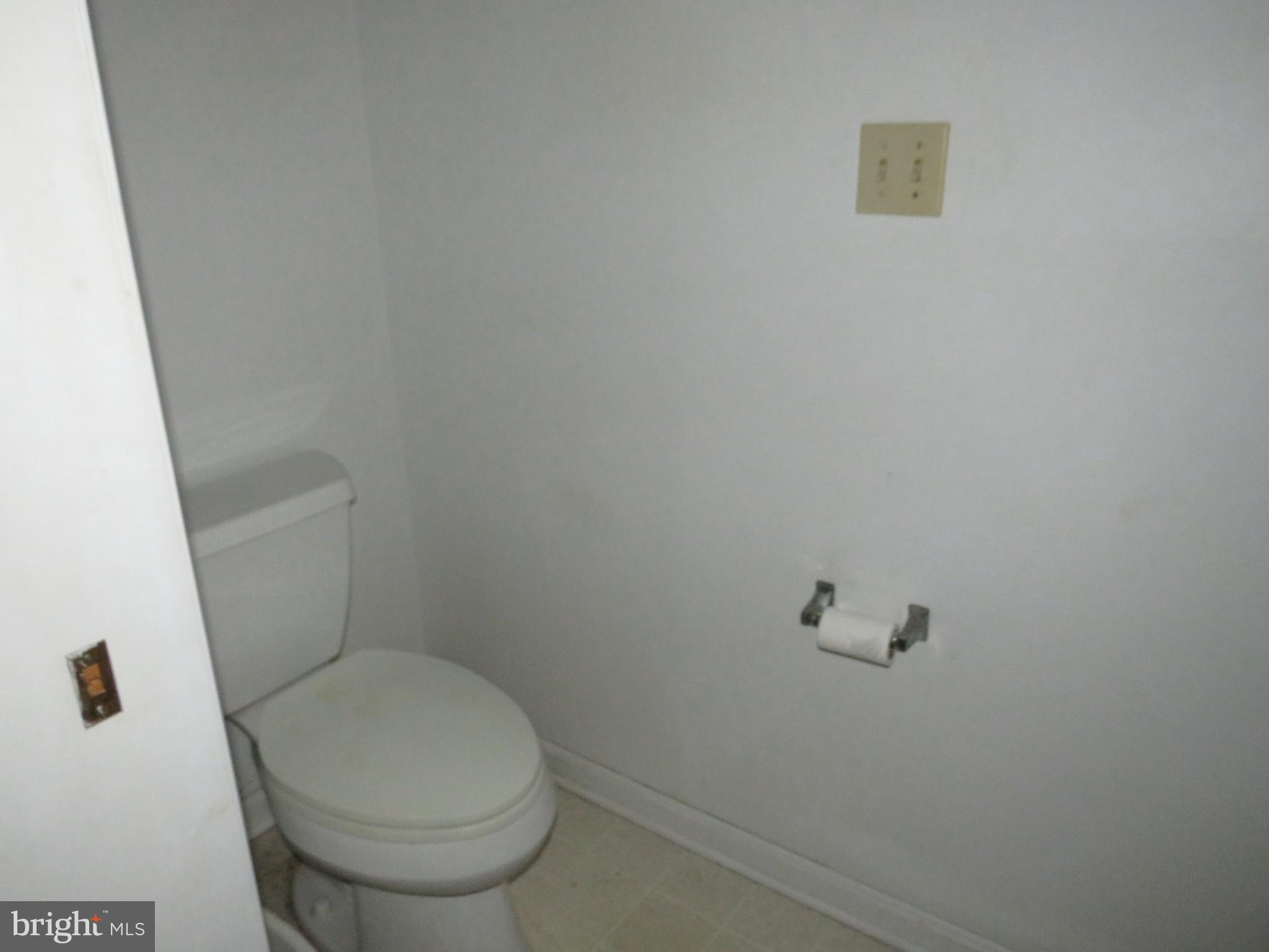 3289 Sackertown Road Crisfield, MD 21817 - Photo 16 of 25 a white toilet sitting next to a white sink