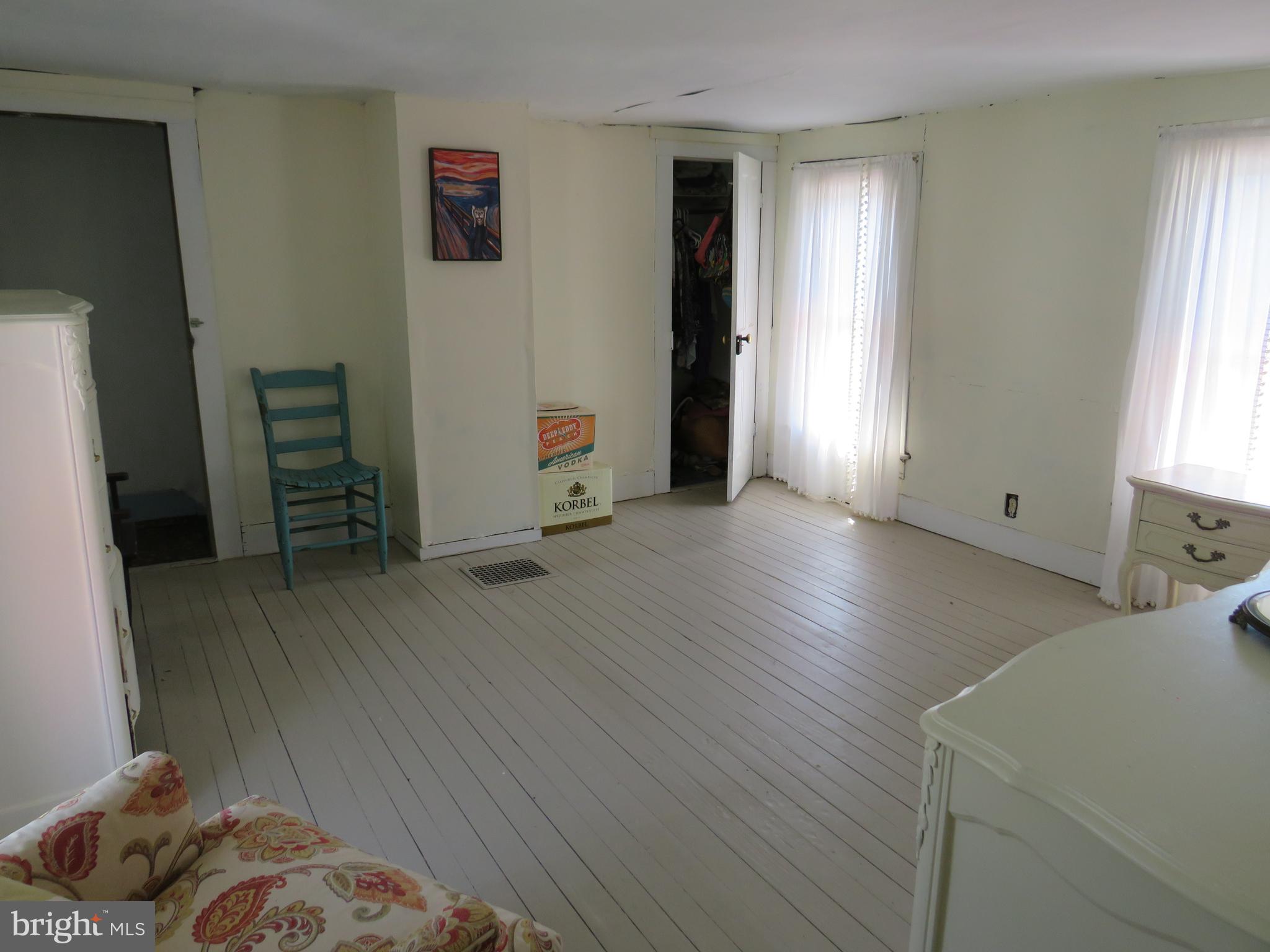 3289 Sackertown Road Crisfield, MD 21817 - Photo 18 of 25 a view of a bedroom with furniture and wooden floor