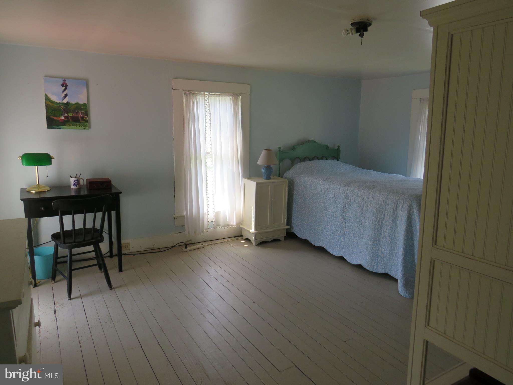 3289 Sackertown Road Crisfield, MD 21817 - Photo 21 of 25 a view of a room that has a bed and a chair in it