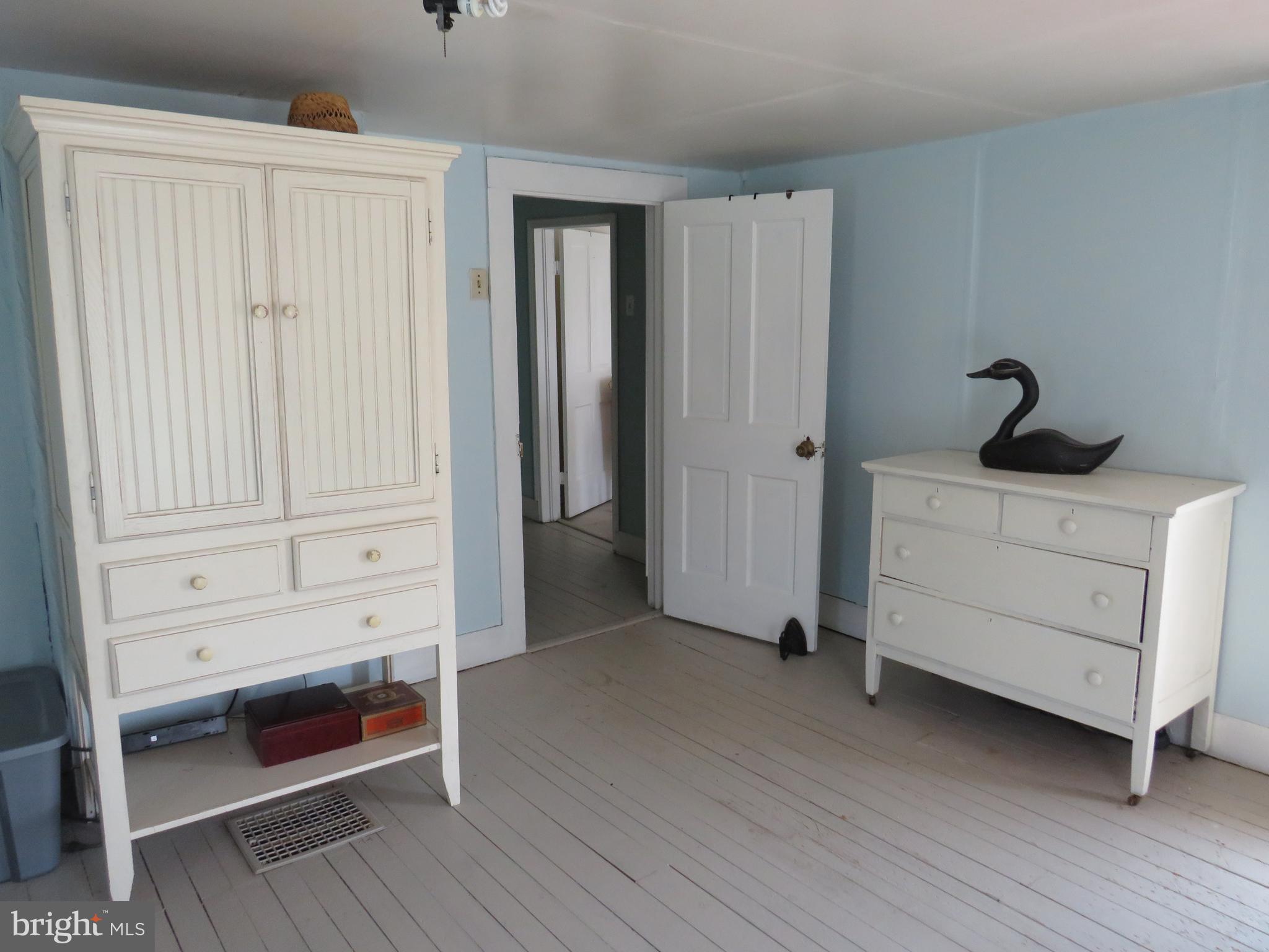 3289 Sackertown Road Crisfield, MD 21817 - Photo 22 of 25 a view of an empty room with closet and wooden floor