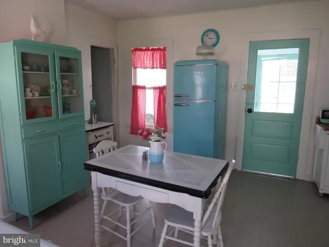 a dining room with a table and chairs