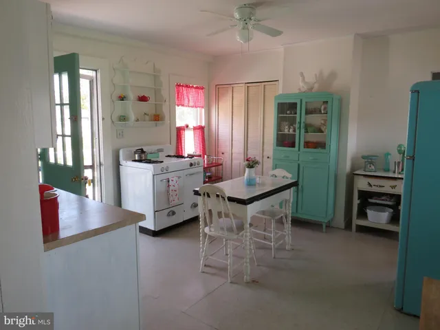a view of a dining room with furniture and a window