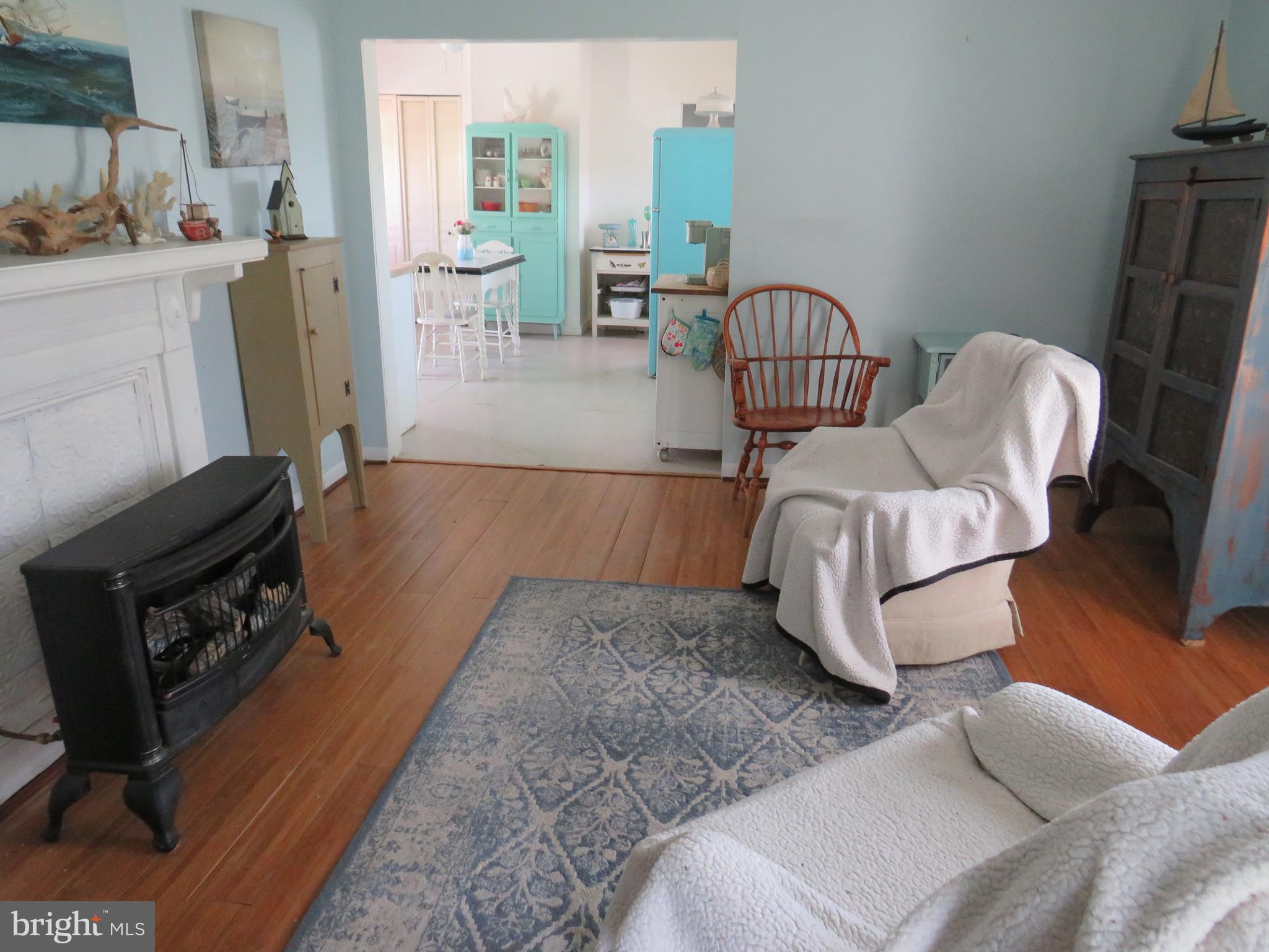 3289 Sackertown Road Crisfield, MD 21817 - Photo 10 of 25 a living room with furniture and a fireplace