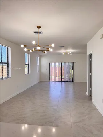 a view of an empty room with a kitchen