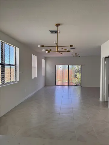 a view of a kitchen with a stove cabinets and a window