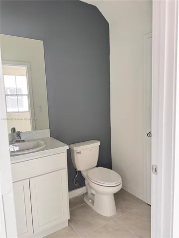 a white toilet sitting next to a bathroom sink