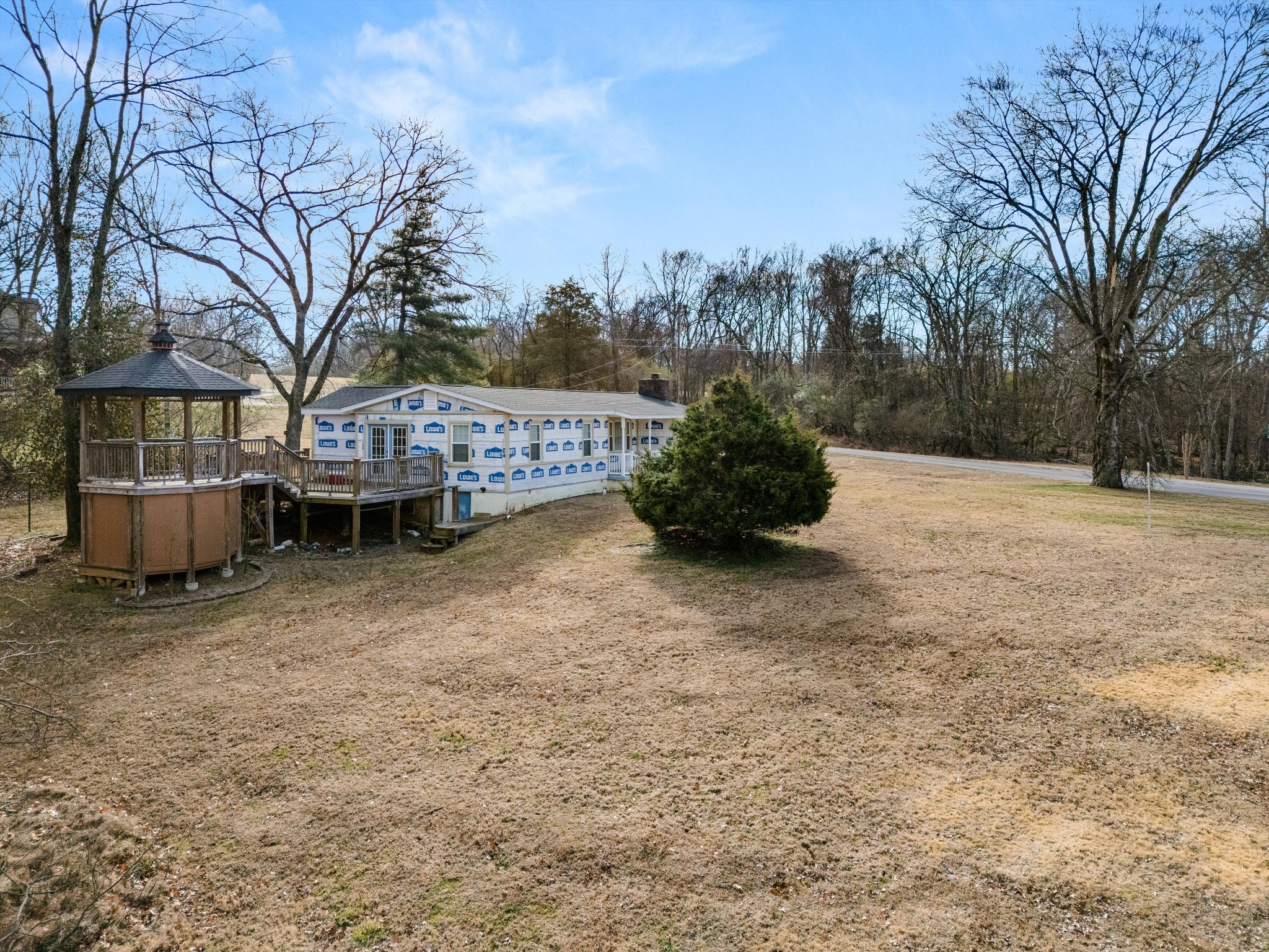 200 Burris Road Mount Juliet, TN 37122 - Photo 17 of 33 a backyard of a house with large trees and wooden fence