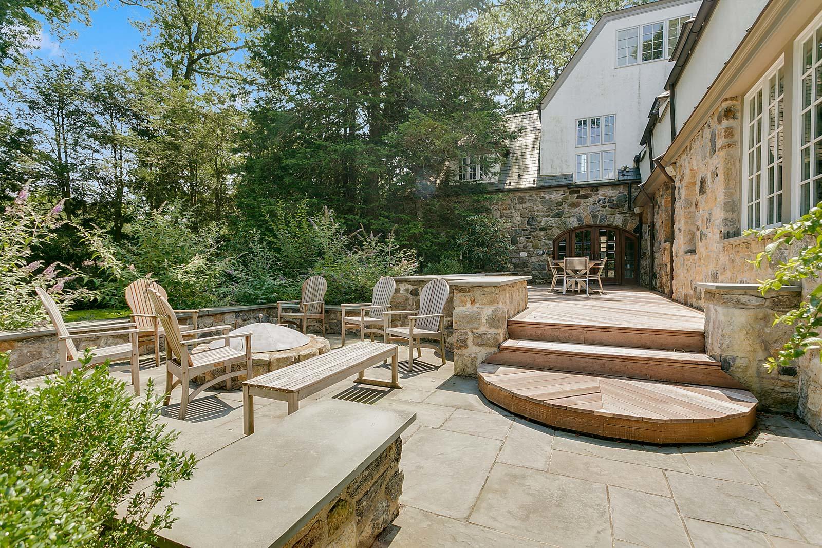 6 Woodley Road Darien, CT 06820 - Photo 6 of 37 a view of a patio with table and chairs and potted plants