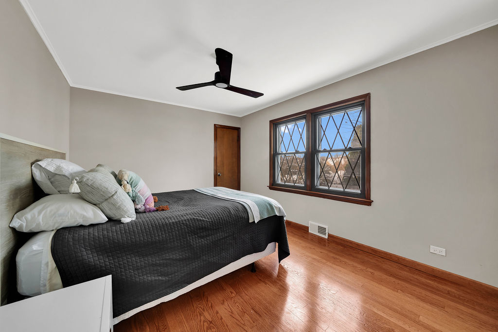 6559 South Kilpatrick Avenue Chicago, IL 60629 - Photo 11 of 26 a bed sitting in a bedroom next to a window