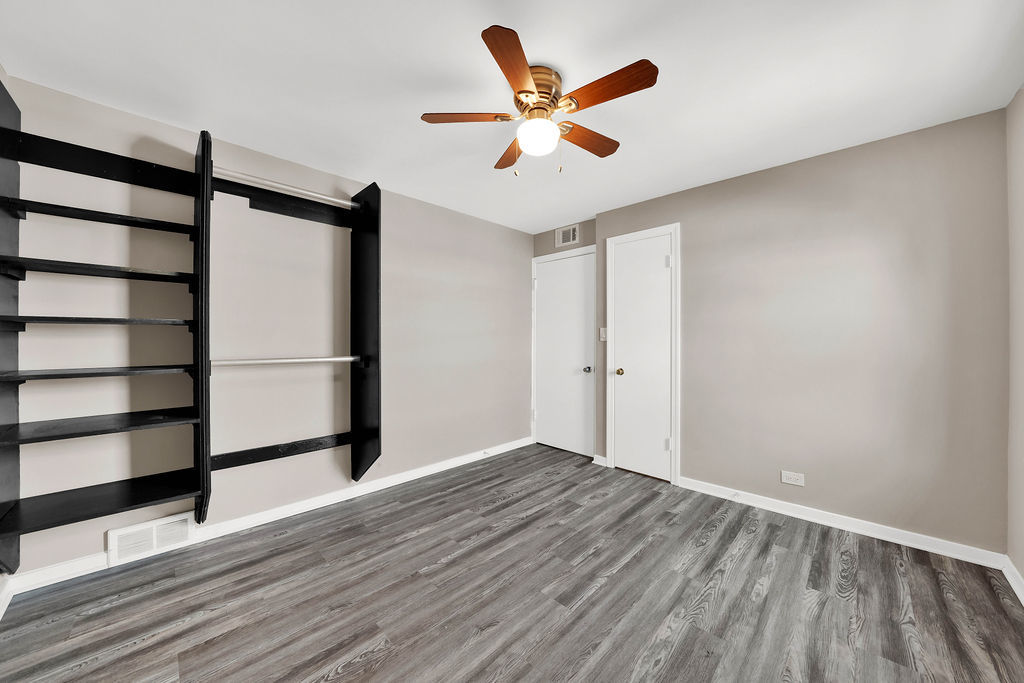 6559 South Kilpatrick Avenue Chicago, IL 60629 - Photo 21 of 26 wooden floor in an empty room with a window