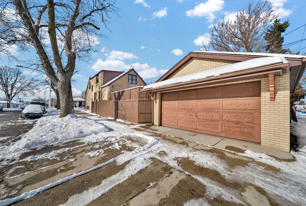 6559 South Kilpatrick Avenue Chicago, IL 60629 - Photo 26 of 26 a front view of a house with a yard and garage