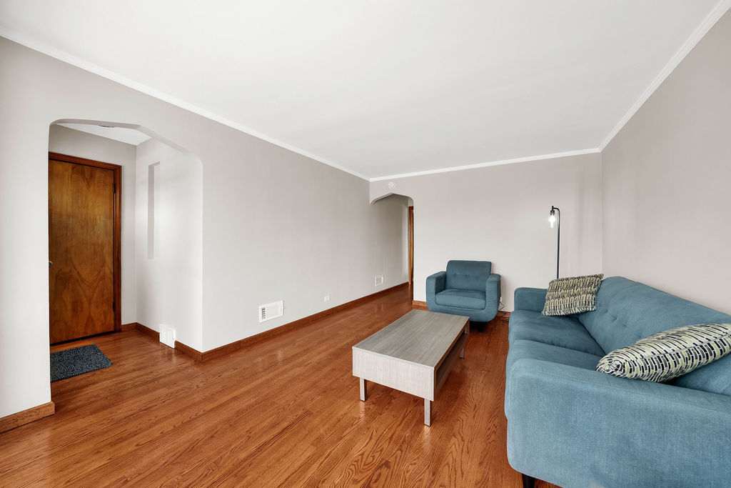 6559 South Kilpatrick Avenue Chicago, IL 60629 - Photo 5 of 26 a living room with furniture and wooden floor