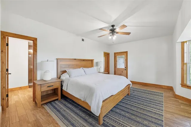 a bedroom with a bed and a ceiling fan