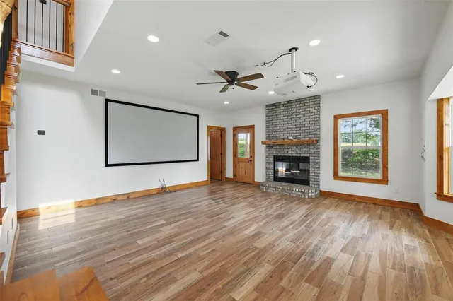 a view of an empty room with a fireplace and a window