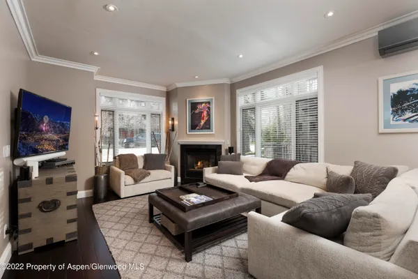 a living room with furniture a flat screen tv and a fireplace
