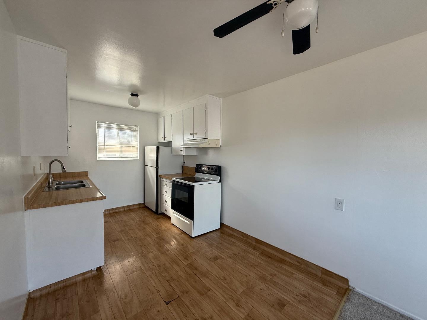 117 Adler Avenue Campbell, CA 95008 - Photo 5 of 7 a kitchen with granite countertop a sink cabinets and stainless steel appliances