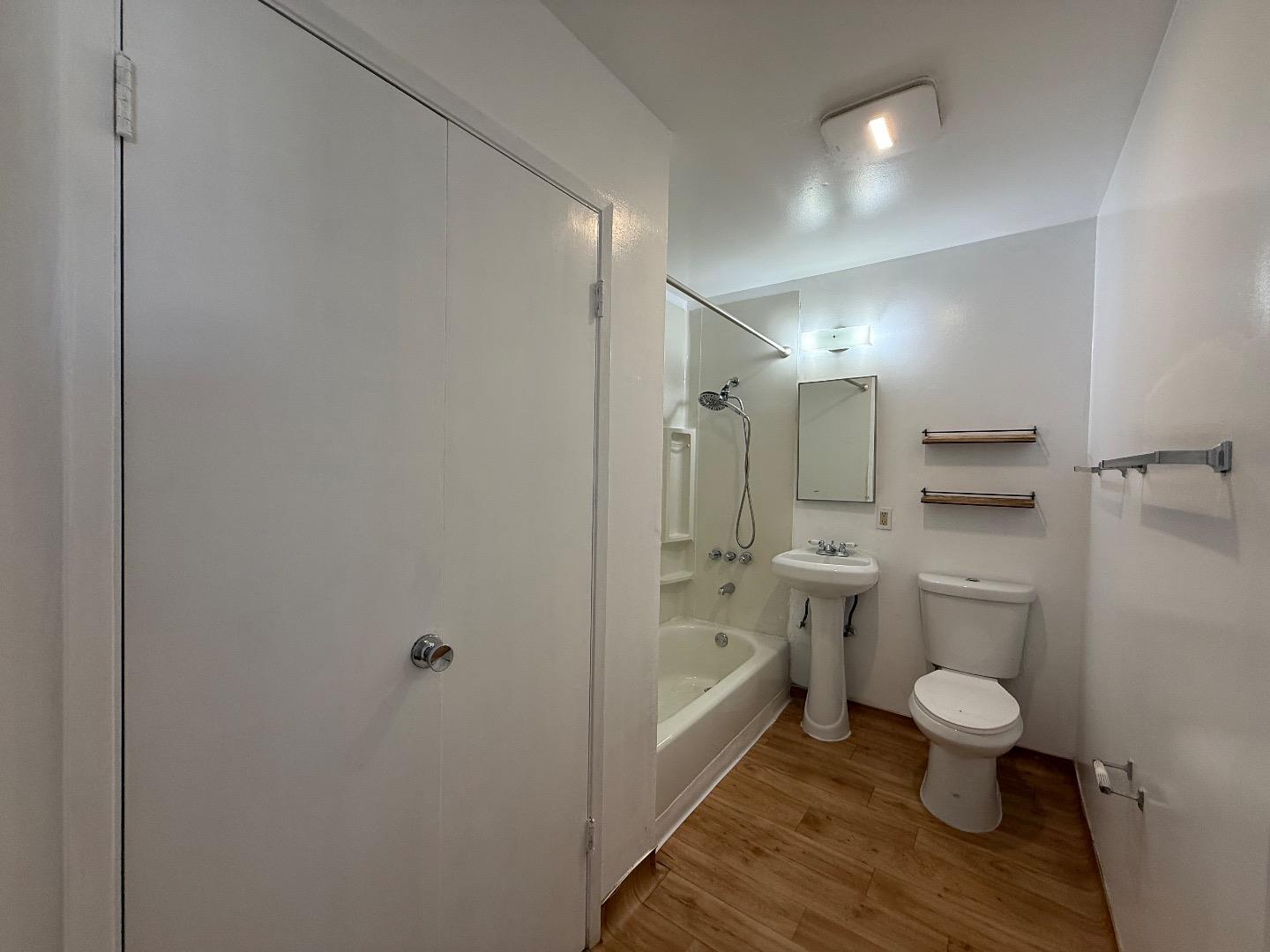 117 Adler Avenue Campbell, CA 95008 - Photo 7 of 7 a bathroom with a granite countertop toilet a sink and a shower