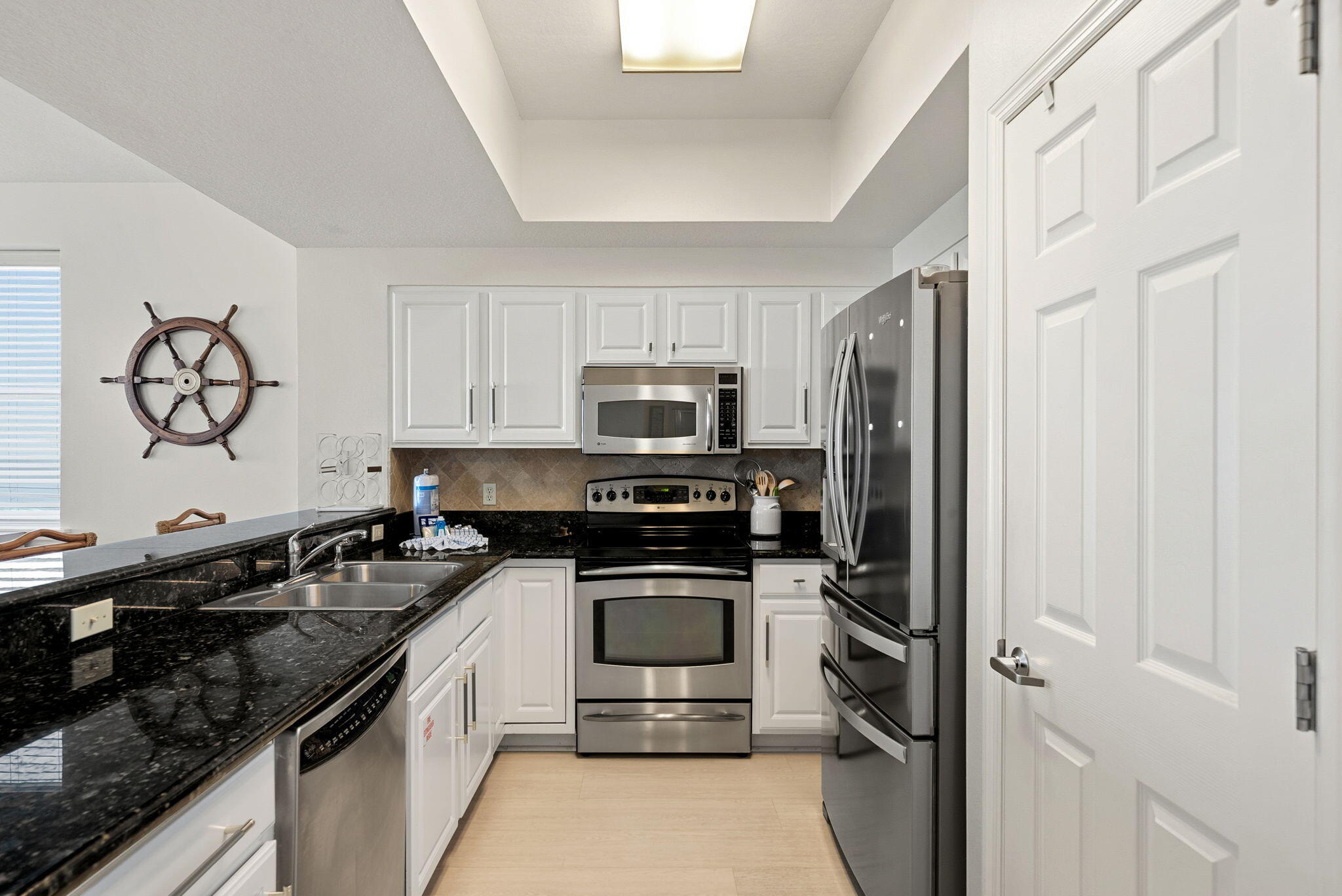 112 Seascape Drive, Unit 1910 Miramar Beach, FL 32550 - Photo 6 of 49 a kitchen with a sink stove and refrigerator