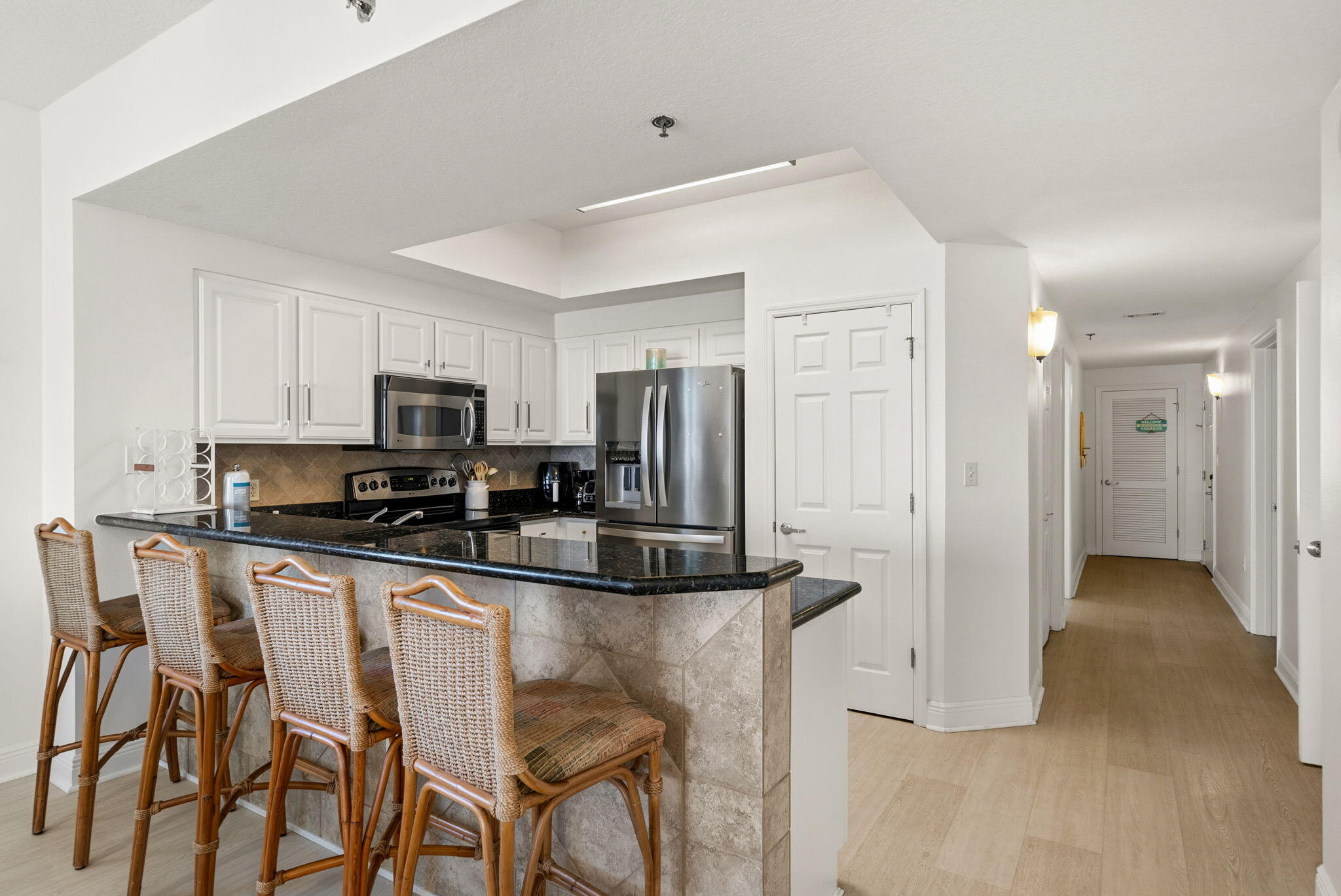 112 Seascape Drive, Unit 1910 Miramar Beach, FL 32550 - Photo 7 of 49 a kitchen with stainless steel appliances kitchen island granite countertop a refrigerator and microwave