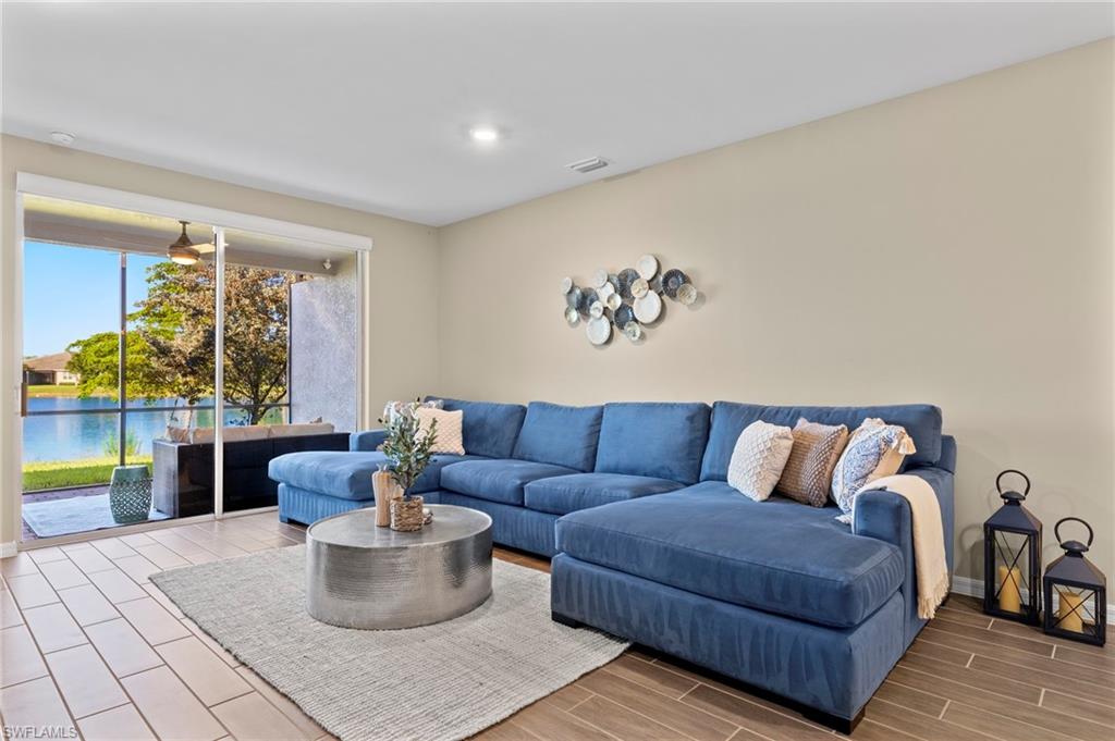 14644 Edgewater Circle Naples, FL 34114 - Photo 3 of 39 a living room with furniture and a potted plant