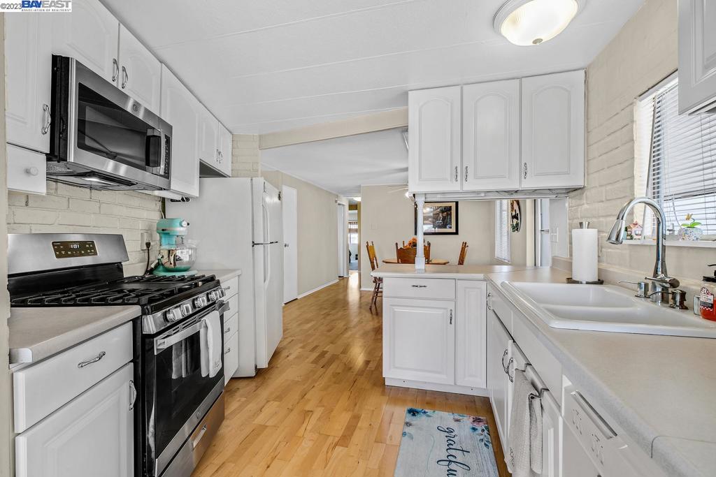 840 Sungold Circle Livermore, CA 94551 - Photo 15 of 28 a kitchen with a sink stove top oven and refrigerator