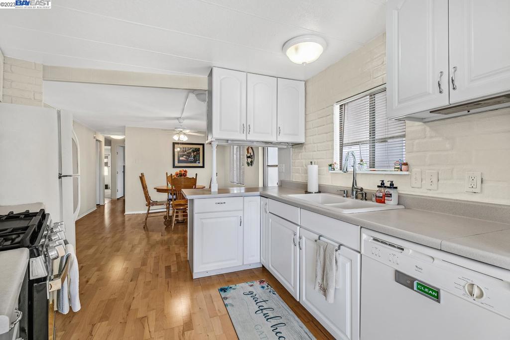 840 Sungold Circle Livermore, CA 94551 - Photo 16 of 28 a kitchen with white cabinets sink and stove