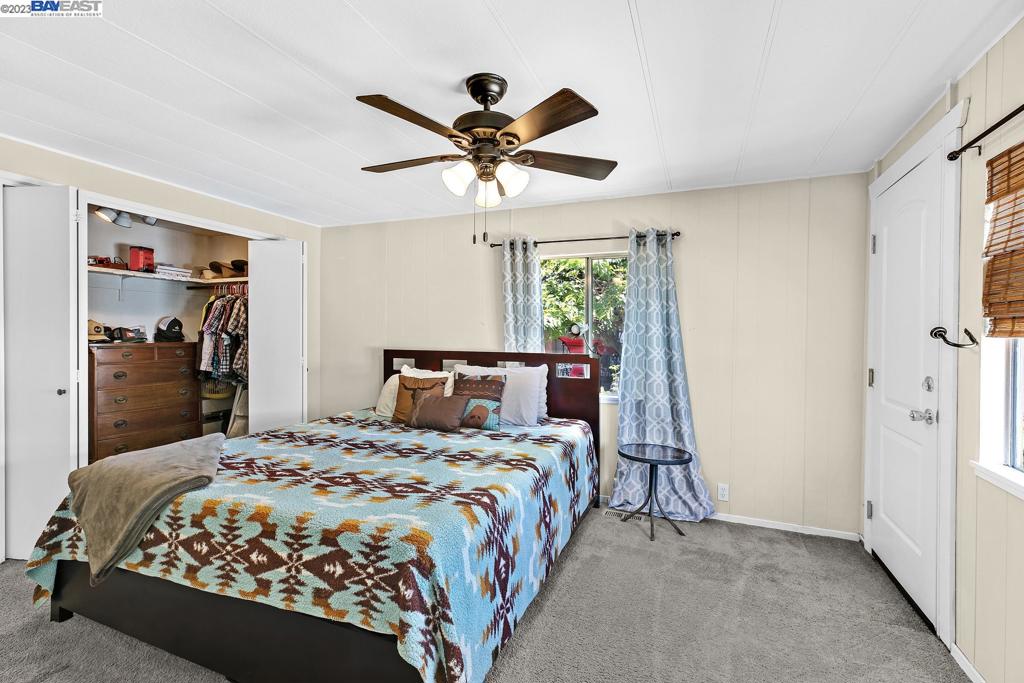 840 Sungold Circle Livermore, CA 94551 - Photo 24 of 28 a bedroom with a bed and a chandelier