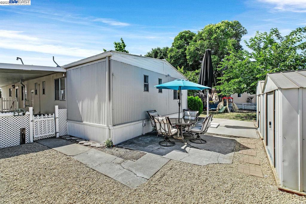 840 Sungold Circle Livermore, CA 94551 - Photo 4 of 28 a view of a patio with a table and chairs under an umbrella