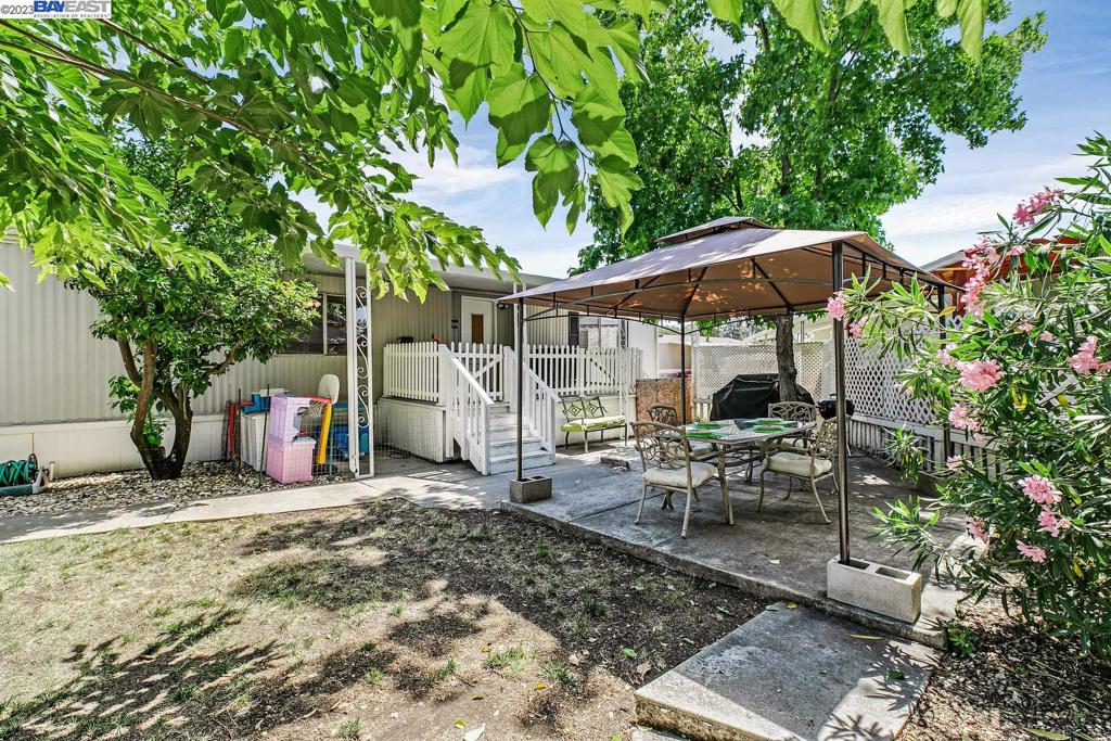 840 Sungold Circle Livermore, CA 94551 - Photo 7 of 28 a view of a patio with table and chairs under an umbrella