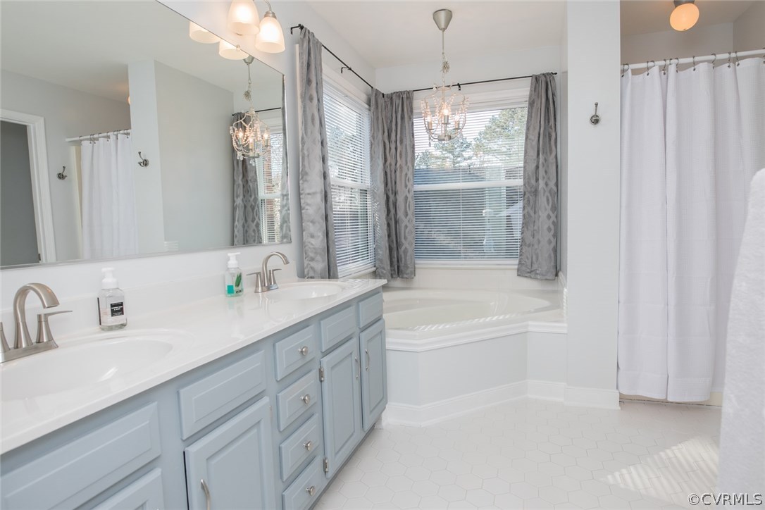 11907 Taplow Road Midlothian, VA 23112 - Photo 16 of 29 a bathroom with a tub sink and mirror