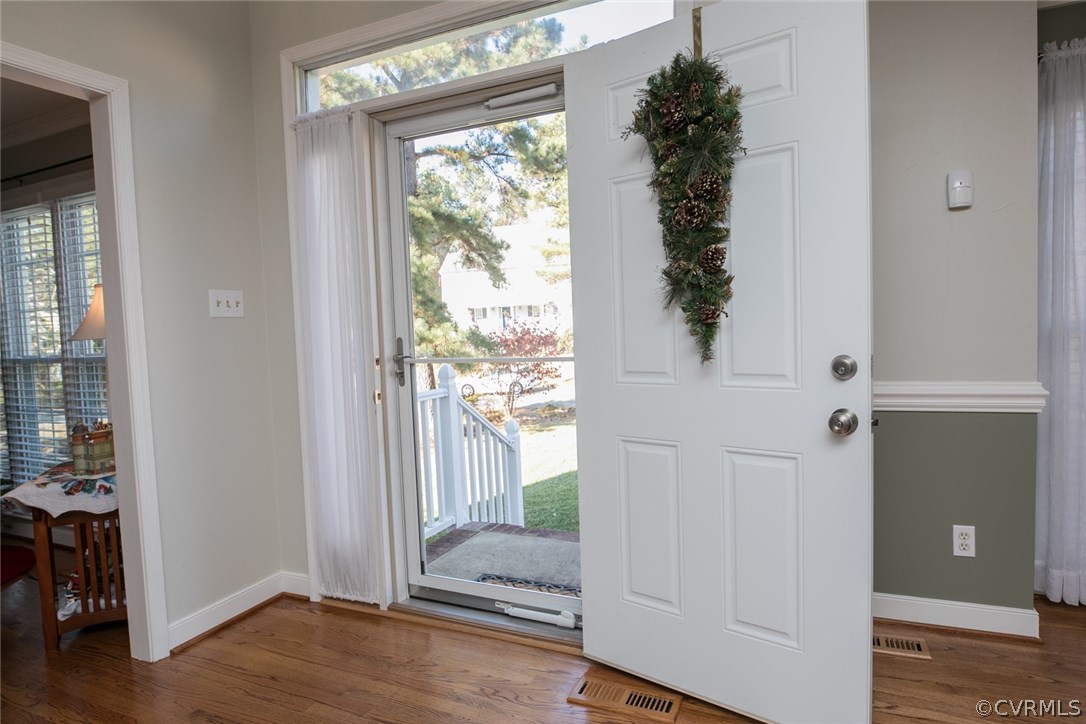 11907 Taplow Road Midlothian, VA 23112 - Photo 3 of 29 a view of a hallway with wooden floor and door