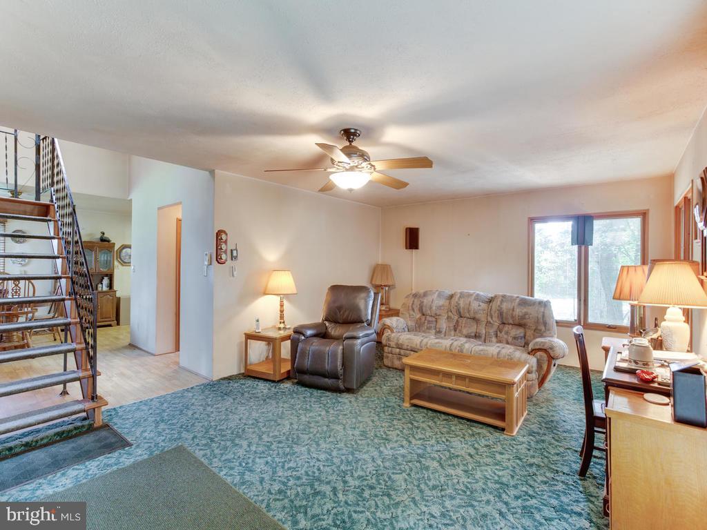 5482 Hallowing Point Road Prince Frederick, MD 20678 - Photo 14 of 39 a living room with furniture and a lamp