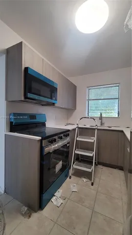 a kitchen with a stove and a microwave