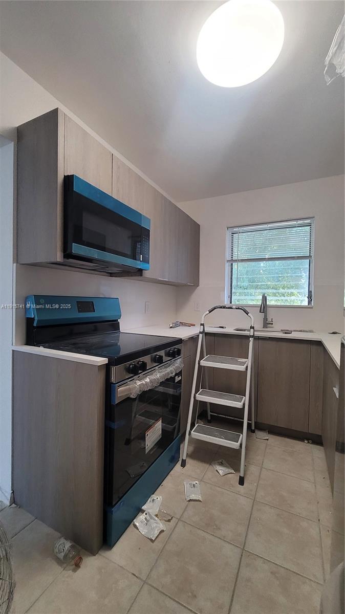 2615 Southwest 22nd Avenue, Unit 5 Miami, FL 33133 - Photo 2 of 10 a kitchen with a stove and a microwave