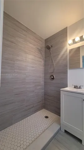 a bathroom with a shower and sink