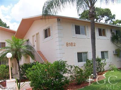 8162 Country Road, Unit 206 Fort Myers, FL 33919 - Photo 1 of 7 a front view of house with yard and green space
