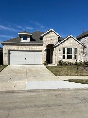 a large kitchen with a center island and stainless steel appliances